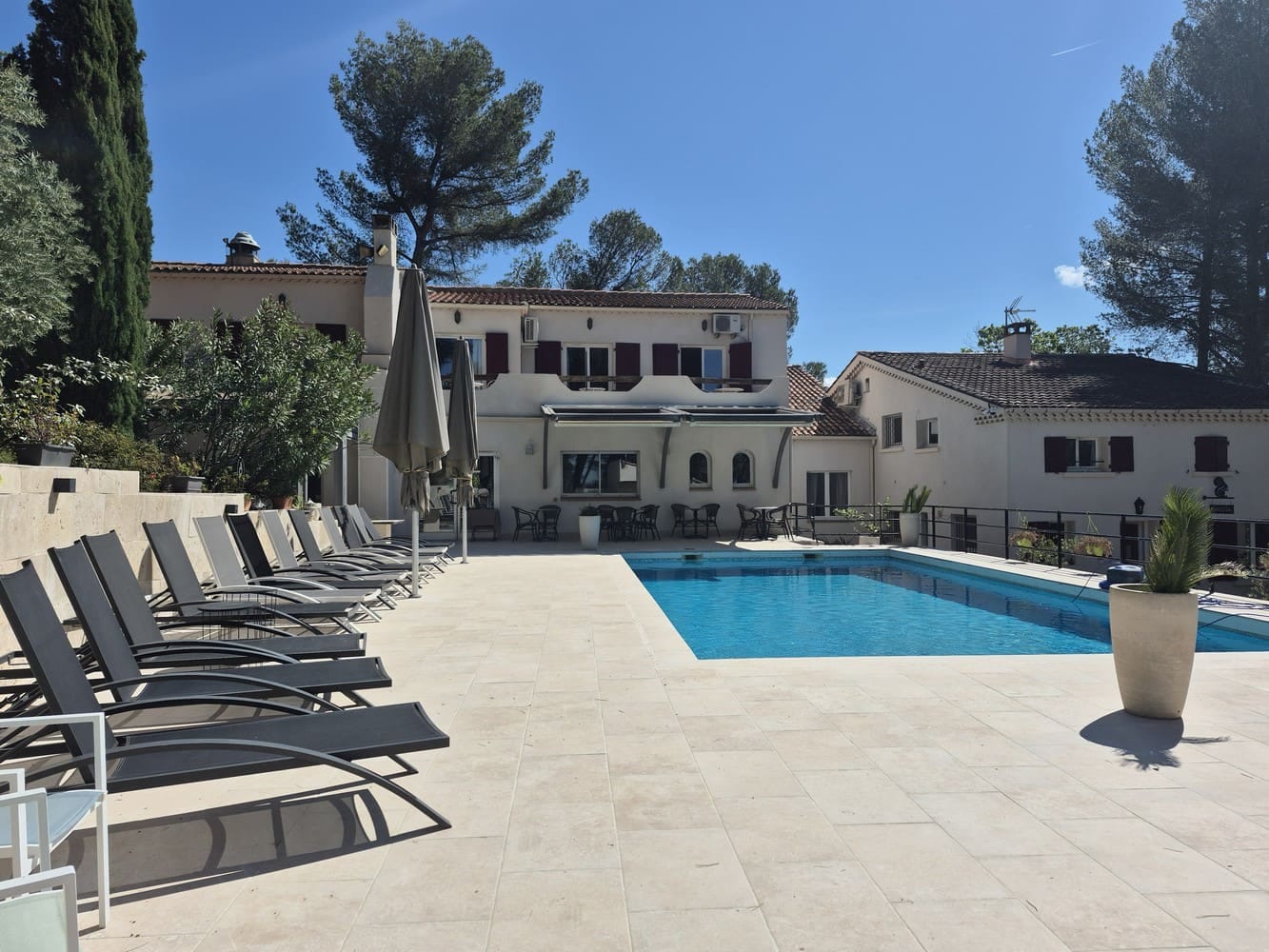 Piscine et terrasse dallée du domaine provençal de La Garrigue, cadre de séminaire au Pôle d'Activités d'Aix