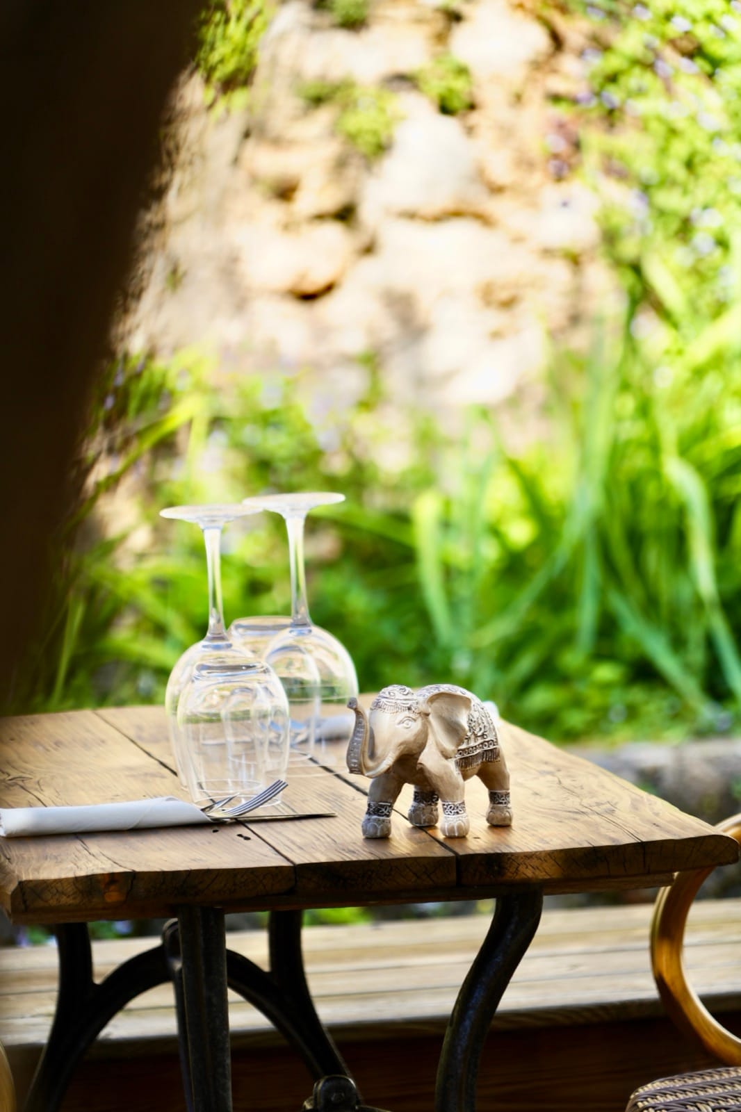 A small wooden elephant set near the glasses, a travel souvenir