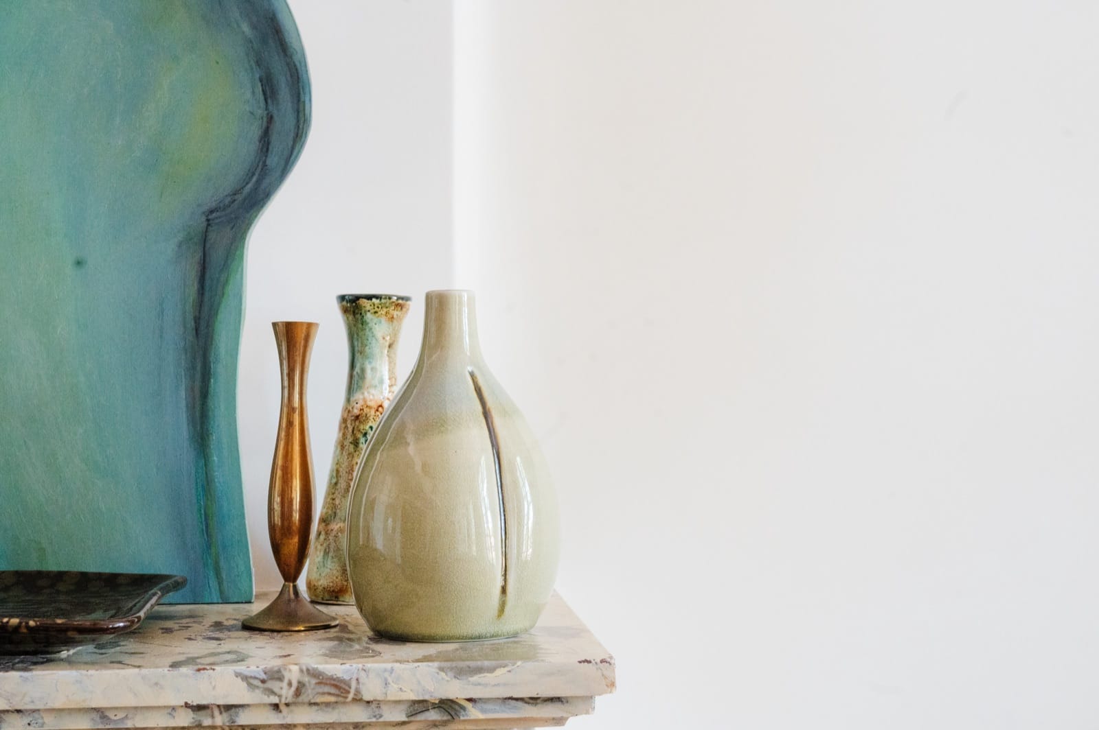 Vintage vases and ceramics set on the marble fireplace
