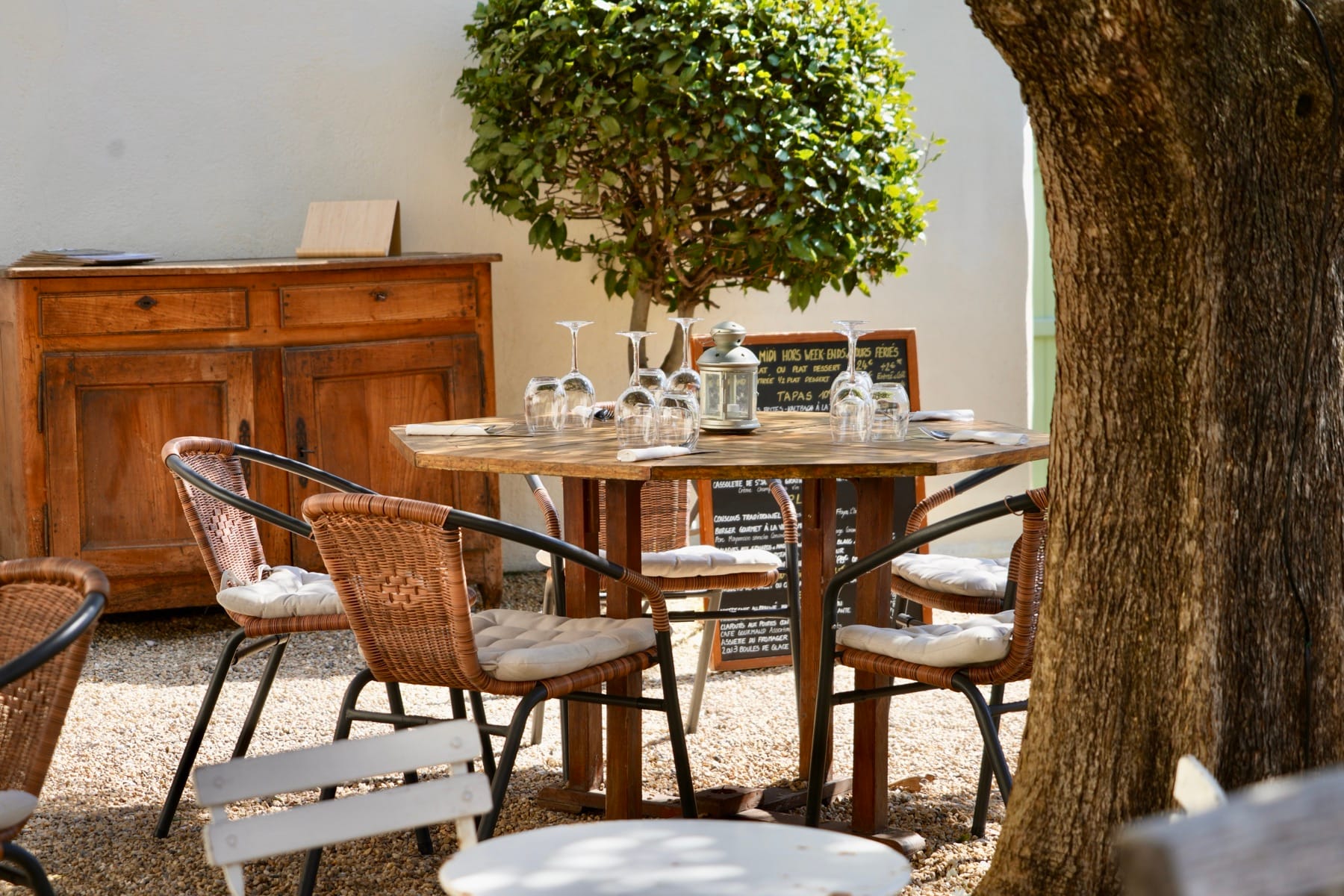 The garden tables beside the menu slates and the antique sideboard