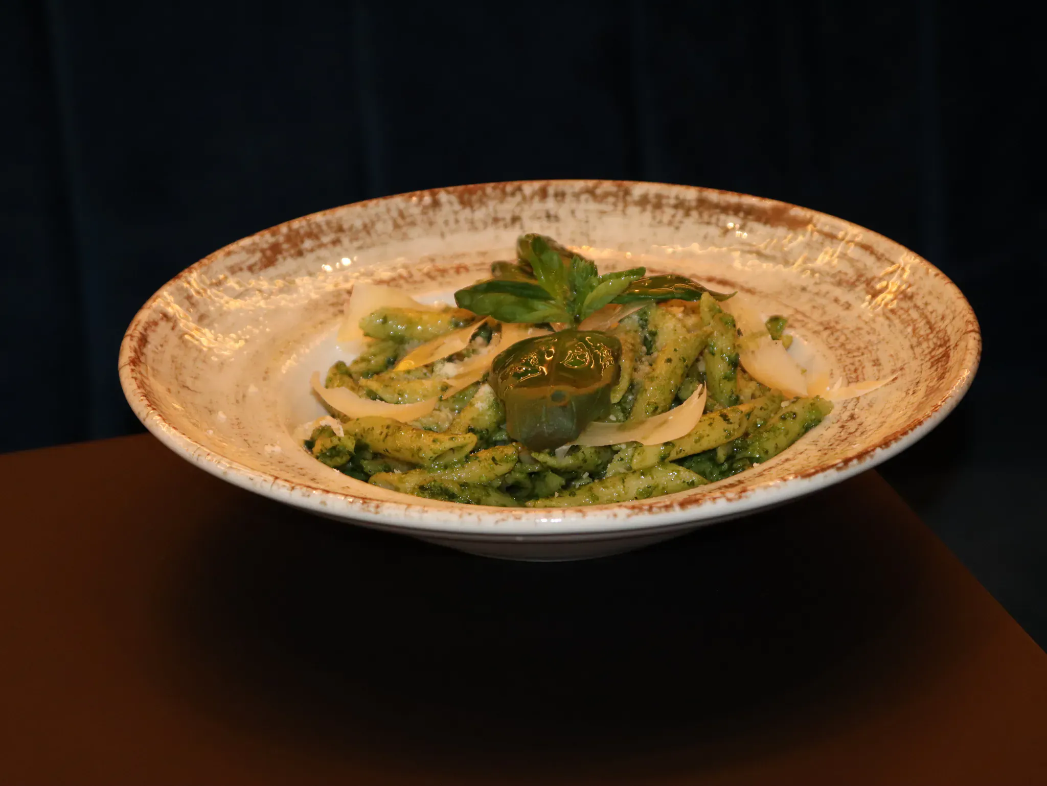 Penne with green pesto and parmesan shavings
