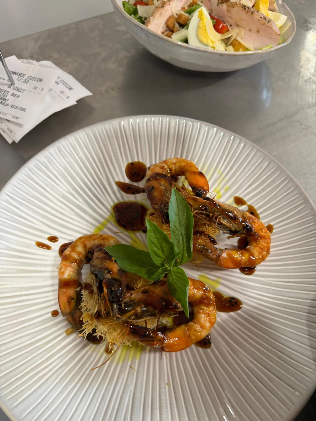 Plate of grilled prawns with sweet-and-savoury sauce plated at Pakal, a world-cuisine restaurant near Luynes.