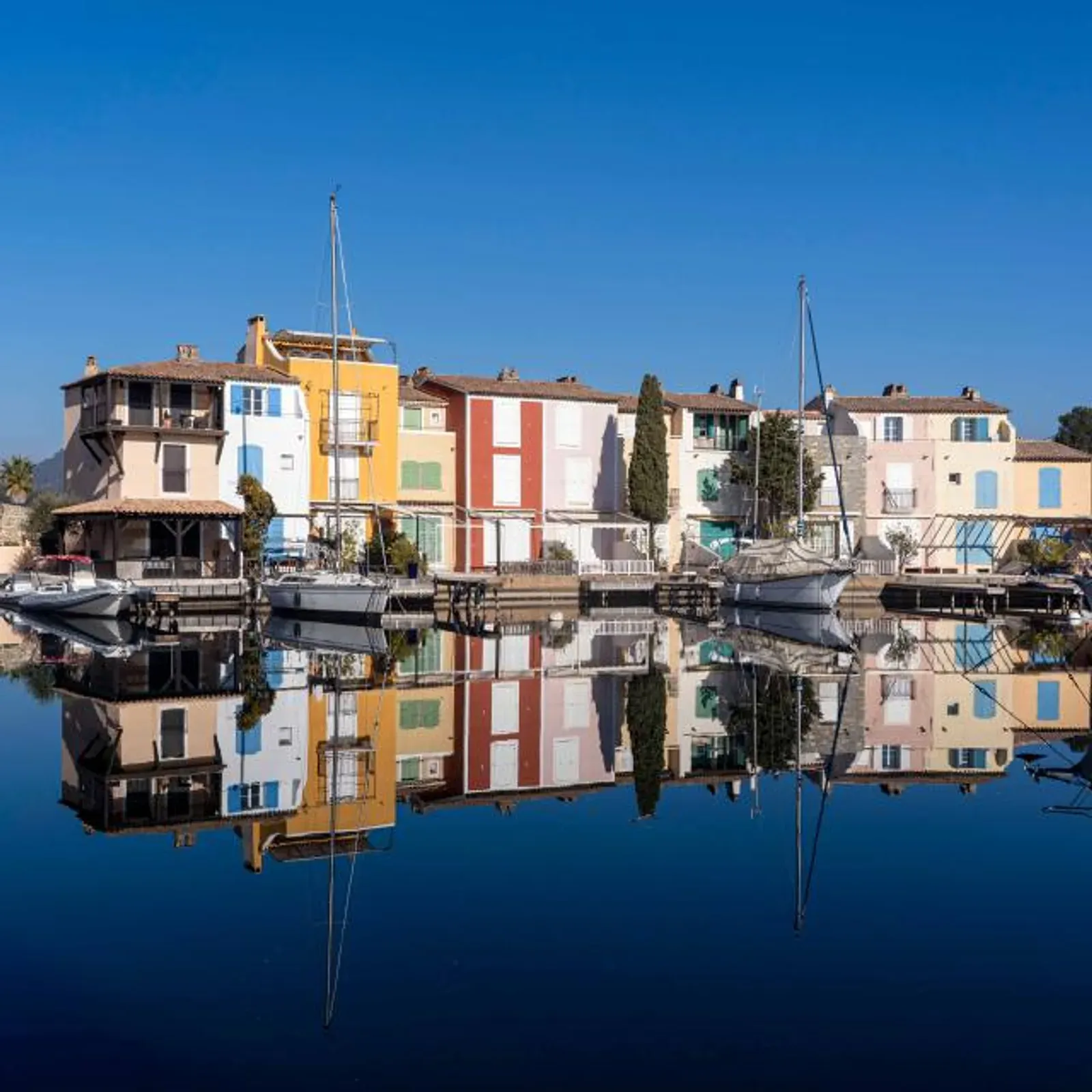 Maisons colorées de Port Grimaud reflétées dans le canal, la Venise provençale