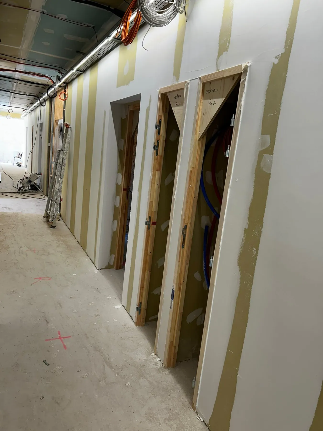 Couloir en plaques de plâtre avec bâtis de portes, joints bandés