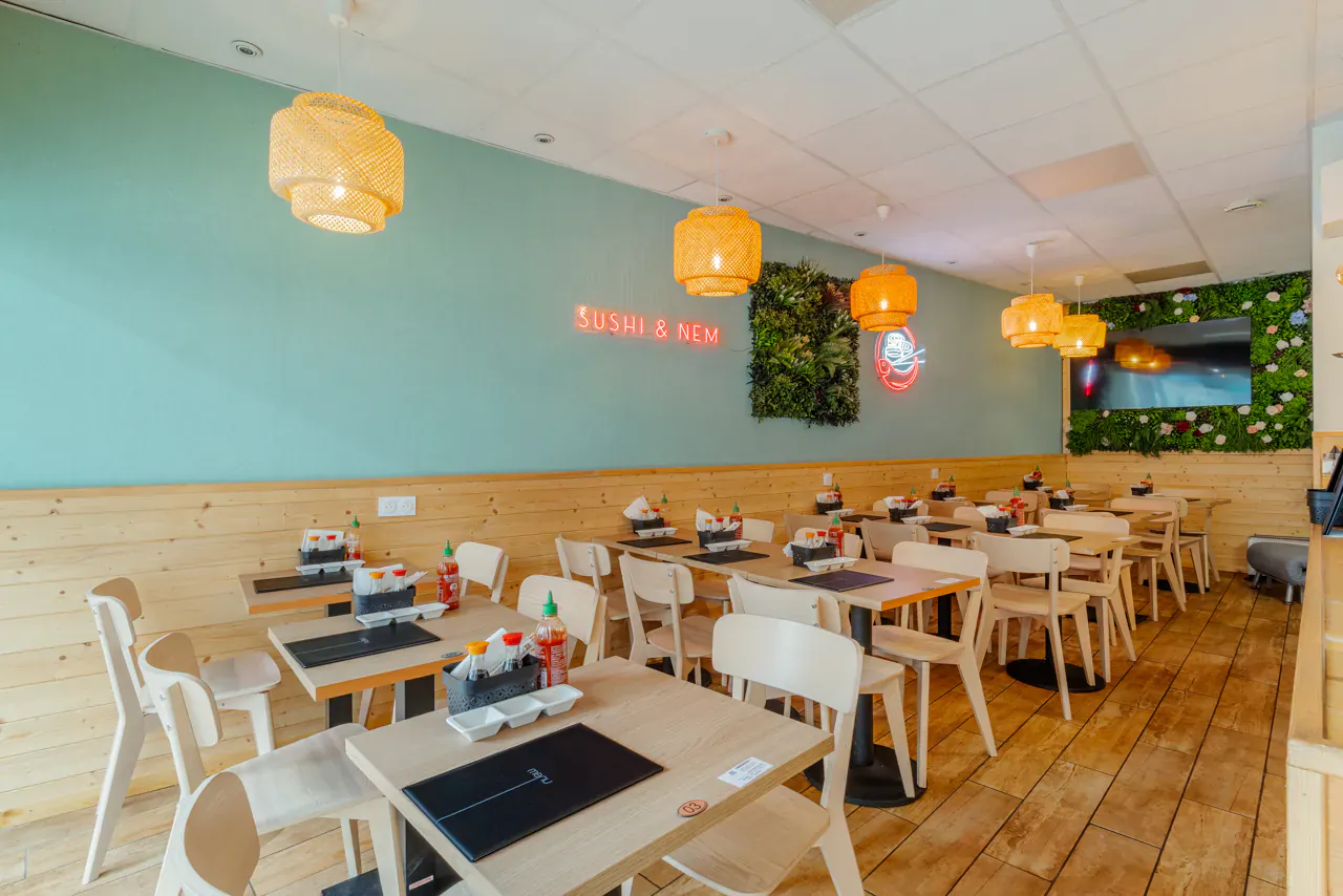 Dining room of Japanese restaurant Sushi & Nem in Thonon with neon sign