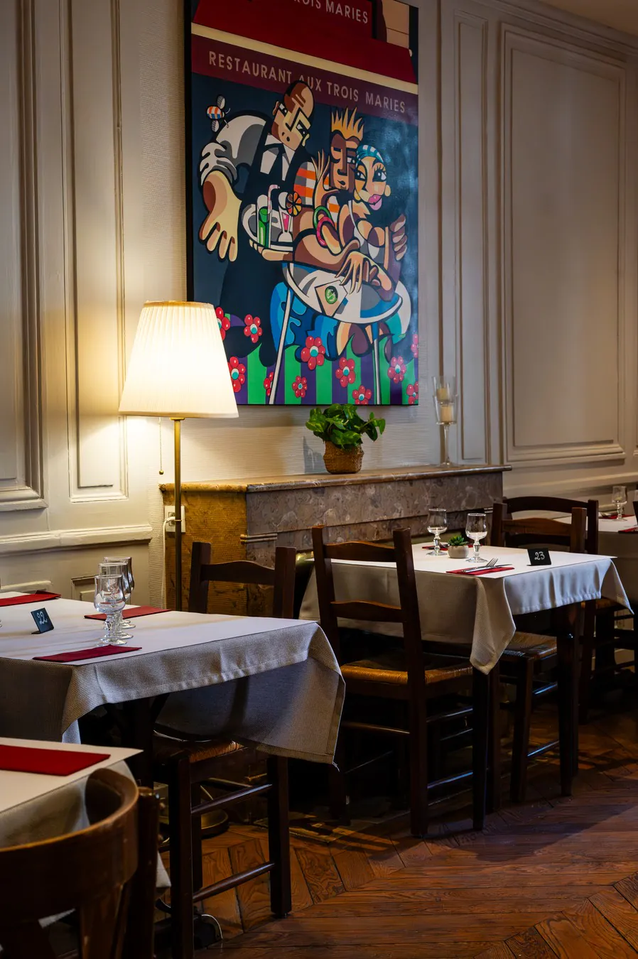 The “Aux Trois Maries” painting above the fireplace, upstairs