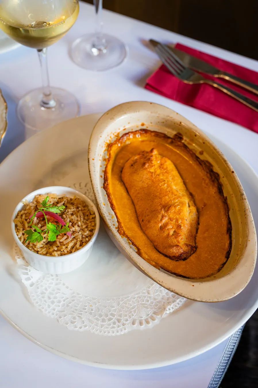 Puffed pike quenelle in its oval dish, pilau rice