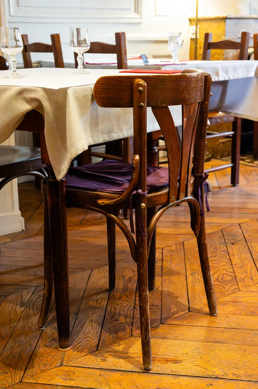 A bentwood bistro chair on the herringbone parquet upstairs