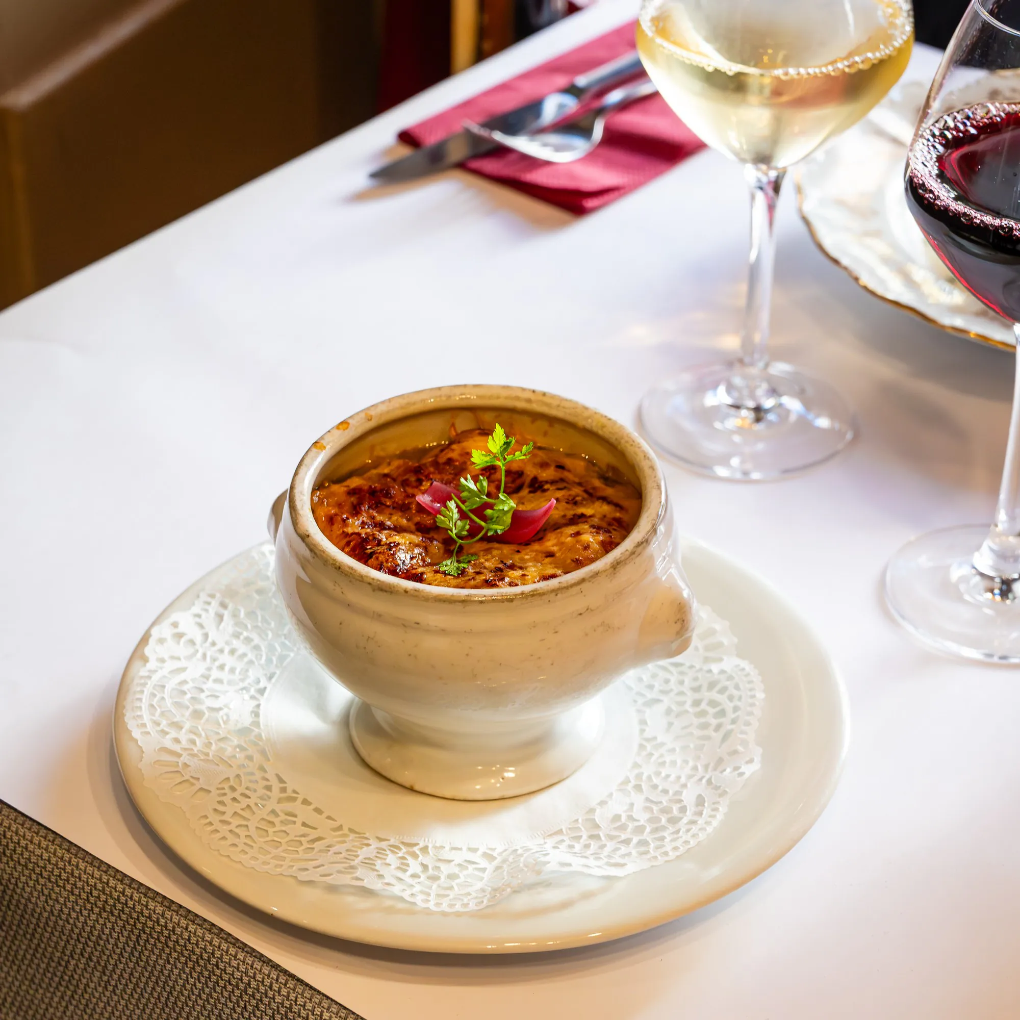 Gratinéed onion soup served in its white tureen