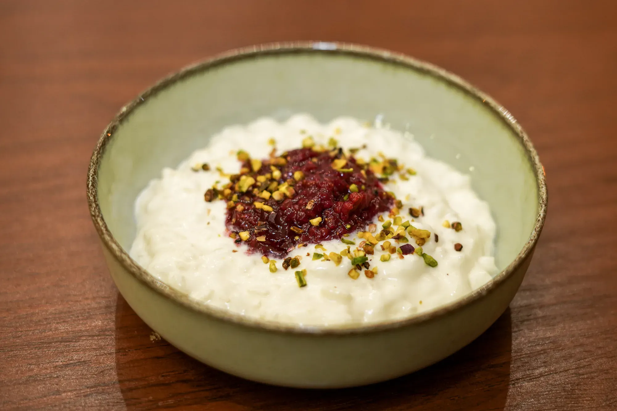 Riz au lait avec compote framboise et pistaches concassees
